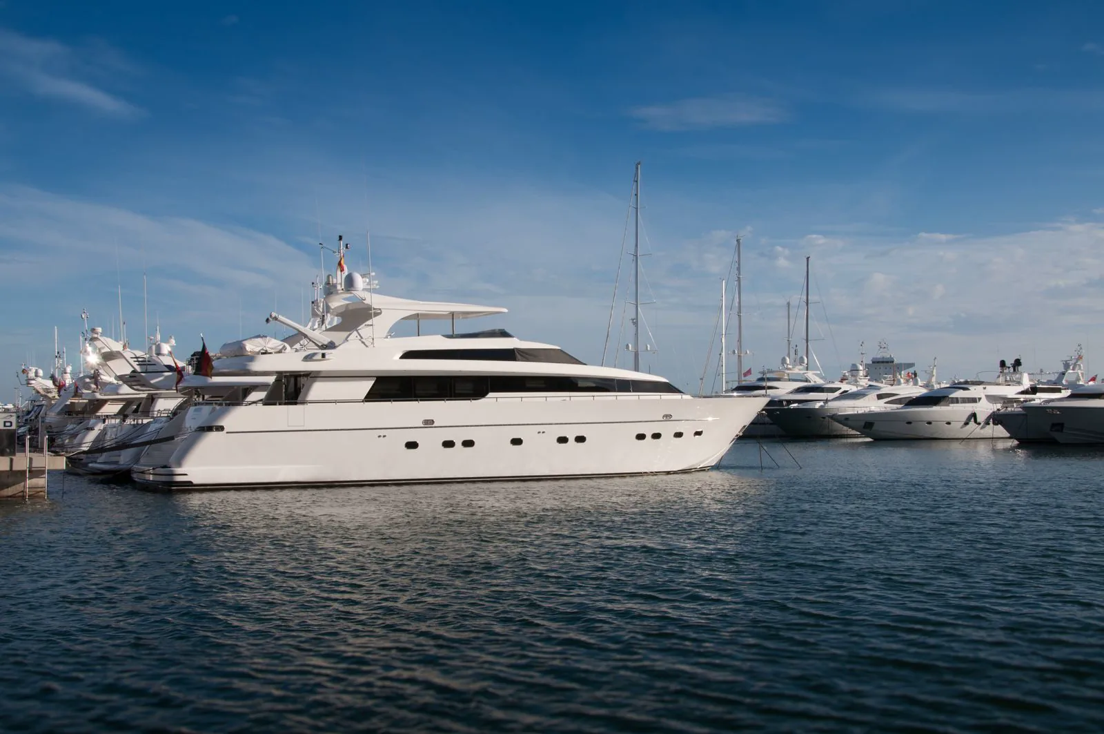 Yachts lined up in a shipyard prepared for transport.